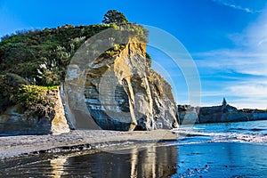 Steep and dangerous White rocks on the Pacific coast. Sunrise. Exotic journey to the end of the world. North Island, New Zealand