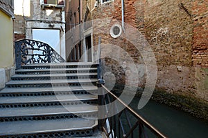 Steep little stone bridge Ponte de la Malvasia Veogina across the canal in Venice