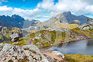 Steep mountains of Lofoten Island on a sunny arctic day. Hermannsdalstinden peak from the trail from Moskenes. Hiking mountains of