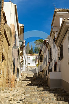 A steep narrow lane typical of the Albaycin district, Granada, Spain photo