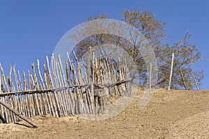 Steep path with wooden fence against a blue sky, Inner Mongolia, Hebei, Mulan Weichang, China, Asia