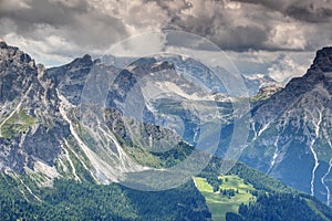 Steep ridges of Sexten Dolomites over forested valleys in Italy