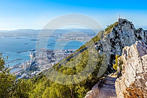 Steep road on the top of Rock of Gibraltar with the city and bay