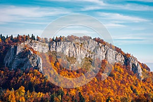 Steep rocky cliff above the forest in fall colors