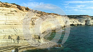 Steep Rocky cliff over the ocean, Beautiful tourist landscape. 4k Aerial view of The Edge of the World and the blue sea