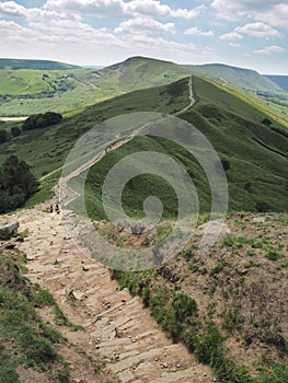The steep rocky descent of Back Tor with Mam Tor in the background, Peak District National Park, UK