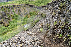 Steep rocky hiking trail to Glymur Waterfall in Iceland