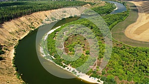 A steep sandy cliff overgrown with forest on the Don River