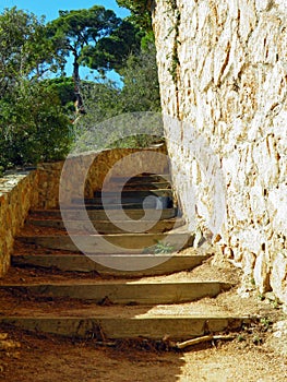 Steep stairs made of rocks along a pedestrian walk way