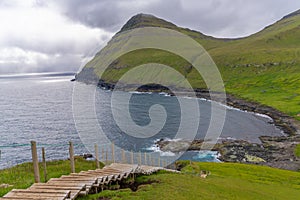 Steep stairs at the beginning of the cliff hike in GjÃÂ³gv gorge, geo, Eysturoy island, Faroe Islands photo