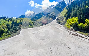 A steep V shaped fluvial valley formed by one of the headstreams of the flowing Ganges river water with steep gradients in