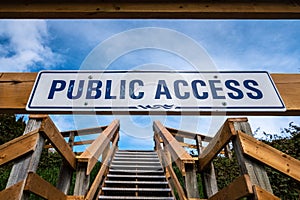 Steep wooden outdoor stairs and sign indicating public access.