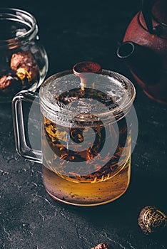 Steeping red tea in glass mug