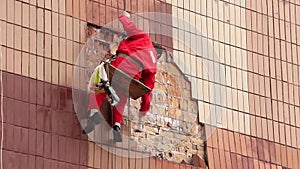 Steeplejack. Worker on a building wall