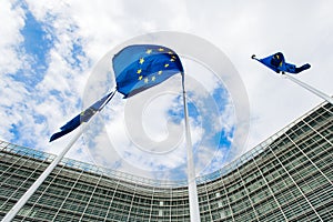 Flags of the European Union against the background of the European Commission building Berlaymont in Brussels, Belgium photo