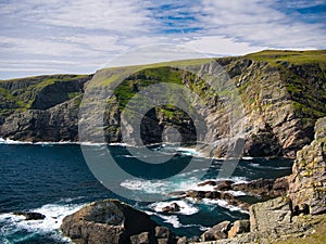 Steeply inclined eroded rock strata on Funzie Ness on the island of Fetlar in Shetland, Scotland, UK