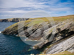 Steeply inclined eroded rock strata on Funzie Ness on the island of Fetlar in Shetland, Scotland, UK