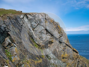 Steeply inclined, fractured strata of the Shetland Ophiolite Complex - Metaharzburgite. Metamorphic Bedrock