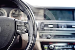 Steering wheel of car, details of buttons and adjustment controls