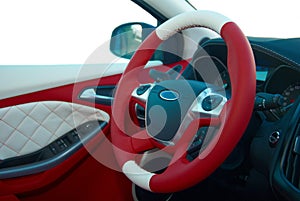 Steering wheel. Car interior details. White red leather with stitching