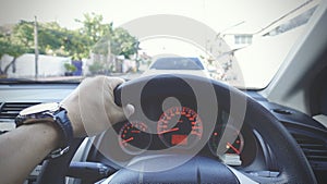 Steering wheel with driver hand on it in car with view of street and another car nearly, Transportation, Businessman driving