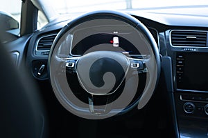 Steering wheel of electric vehicle, interior, cockpit, electric buttons. Autonomous car. Driverless car. Self-driving