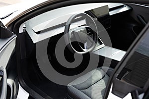 Steering wheel of a electric vehicle, interior cockpit, electric buttons, digital speedometer, front seats, textile