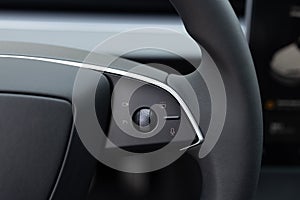 Steering wheel of electric vehicle, interior, cockpit, electric buttons. Electric car interior luxury. Interior of