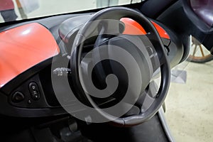 Steering wheel of electrocar - car inside driver place: close up