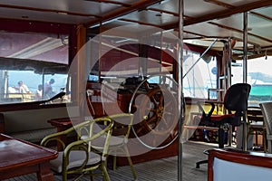 Steering wheel and engine controls on the ship bridge of a pleasure craft