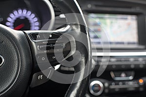 The steering wheel features cruise control buttons forward back