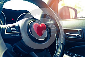 Steering wheel with heart red object.Love car concept idea.interior console car.