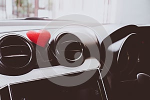 Steering wheel with heart red object.Love car concept idea.interior console car