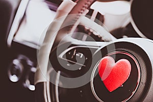 Steering wheel with heart red object.Love car concept idea.interior console car