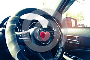 Steering wheel with heart red object.Love car concept idea.interior console car.