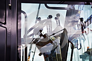 Steering wheel and levers in cockpit of motor grader