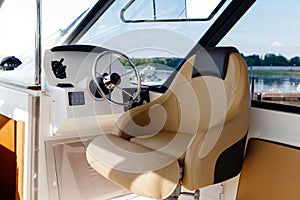 Steering wheel on a luxury yacht cabin.