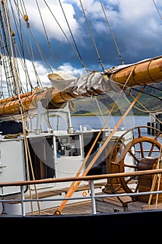 Steering Wheel And Navigation Bridge Of An Old Sail Boat Anchoring In Ullapool In Scotland