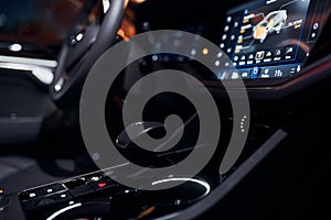 Steering wheel and navigation display. Close up view of front park of new modern black automobile