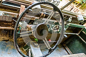 Steering wheel of a old rusty car wreck, interior of a wrecked vehicle