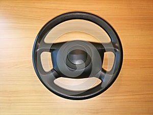 Steering wheel plastic black, removed from the car and placed on the desk