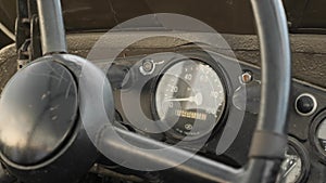 Steering wheel and speedometer of old retro USSR car, close up view. Vintage car, view from inside of details