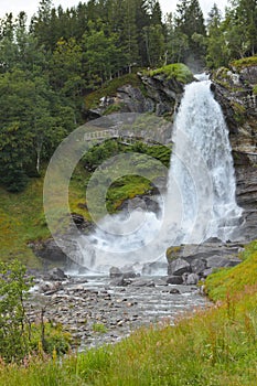 Steinsdalfossen Waterfall. Norway. Summer. Waterfall among the forest on the rocks