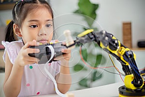 STEM education concept. Asian students learn at home by coding robot arms in STEM, mathematics engineering science technology