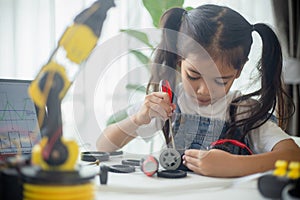 STEM education concept. Asian young girl learning robot design