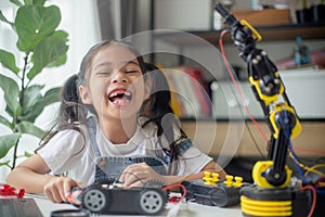 STEM education concept. Asian young girl learning robot design