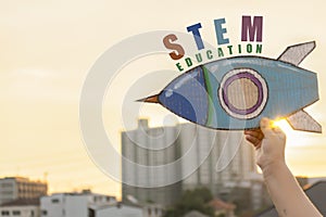 STEM Education concept. Kids are holding a rocket paper,STEM tex