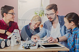 Stem education. Kids creating robots with teacher