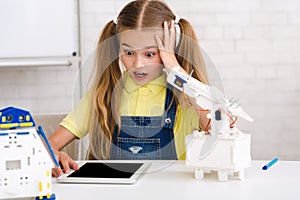 Stem education. Shocked girl made mistake when creating robot