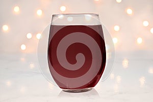Stemless wine glass mockup with red wine and lights